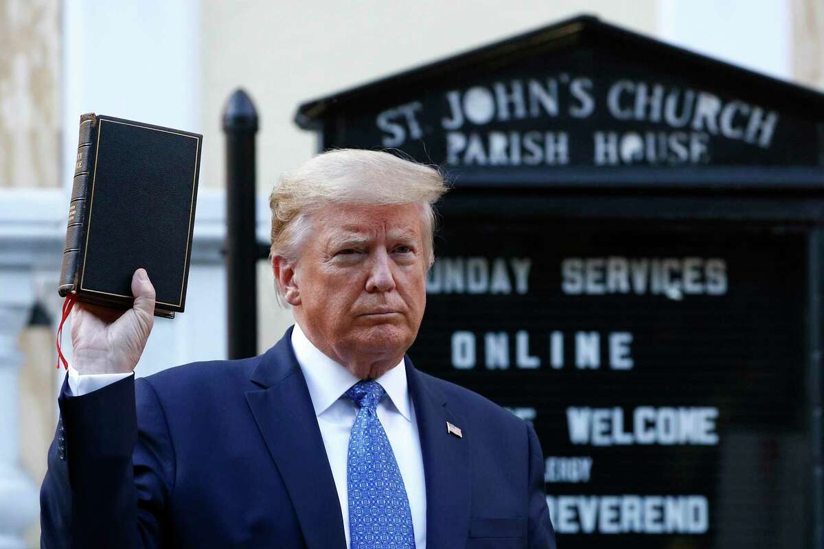 In this Monday, June 1, 2020 file photo, President Donald Trump holds a Bible as he visits outside St. John's Church across Lafayette Park from the White House in Washington. Part of the church was set on fire during protests the previous night.