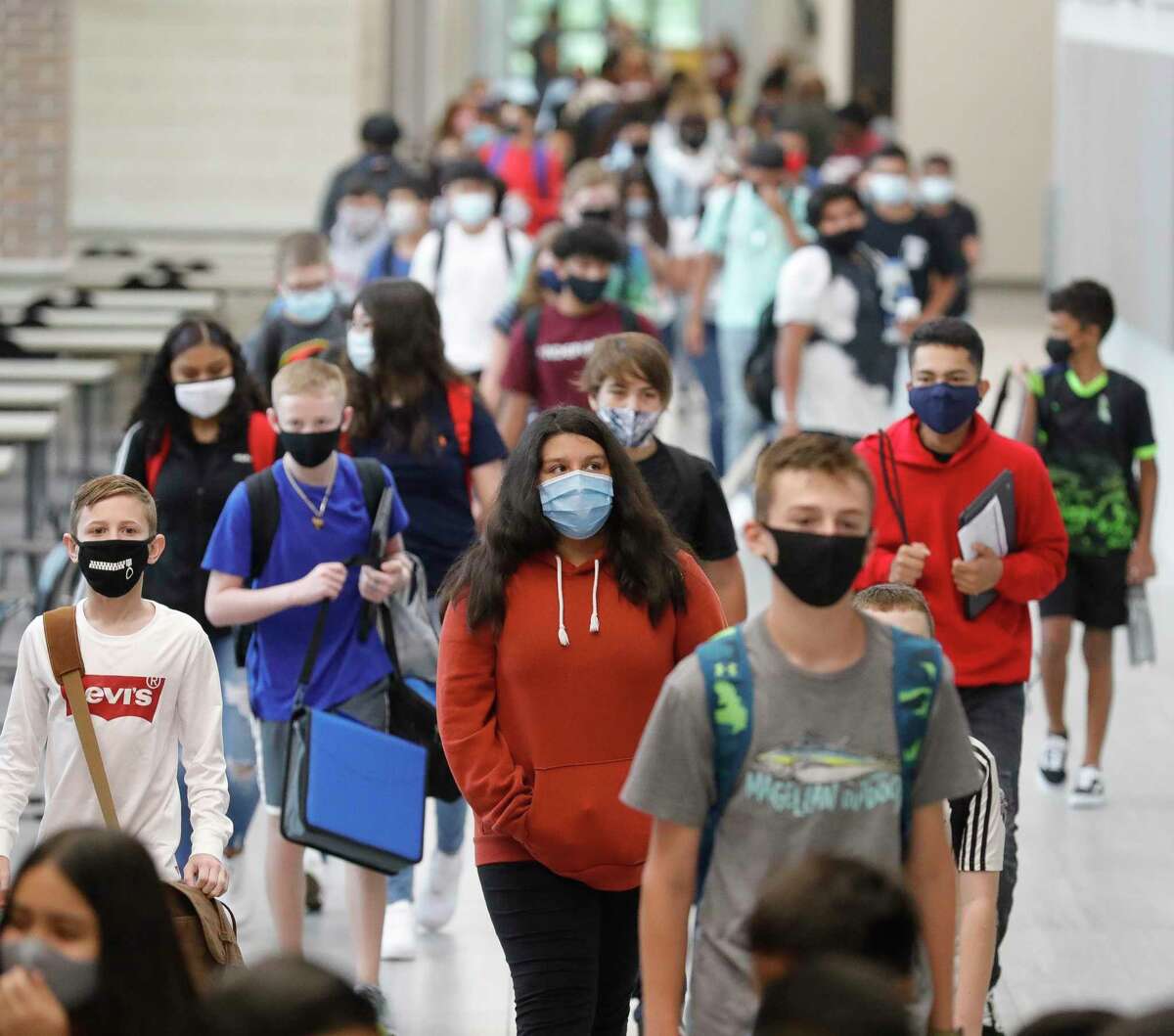 Students wear face masks while walking the hallways of Stockton Junior High School on the first day of in-person school for Conroe ISD, Tuesday, Sept. 8, 2020, in Conroe.