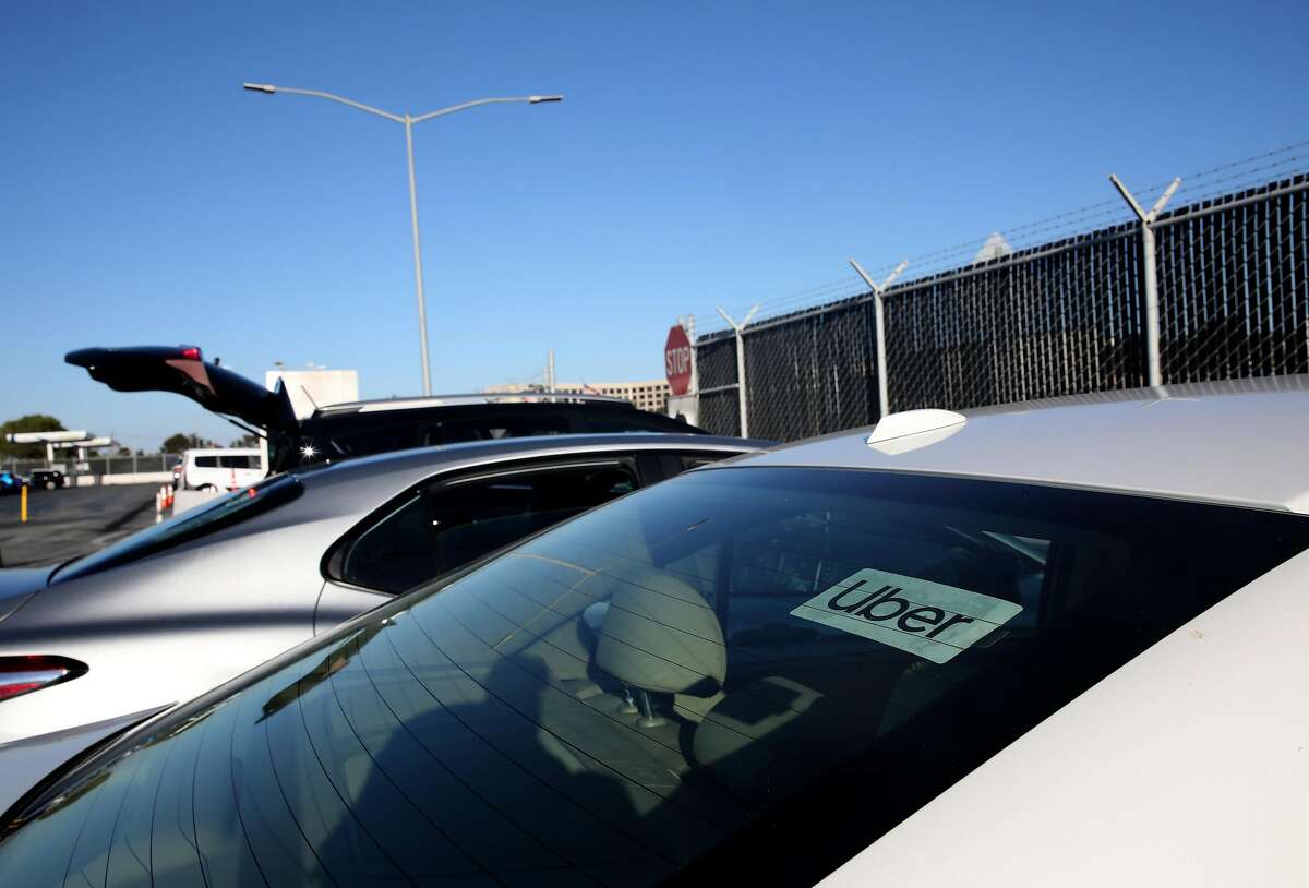 From a staging area, Uber driver Omer Iltas, 43, of San Mateo, prepares to pick up a customer at the San Francisco International Airport on Wednesday, August 12, 2020, in San Francisco, Calif. Iltas has been driving for the ride service since 2013. Uber CEO says service may have to shut down at least temporarily in California if drivers are ruled employees. It is not clear if his statement is a realistic threat or jawboning as the company continues its legal and political jousting around AB5 and Prop. 22. It also appears, at least on the surface, to contradict recent financial disclosures by the company.