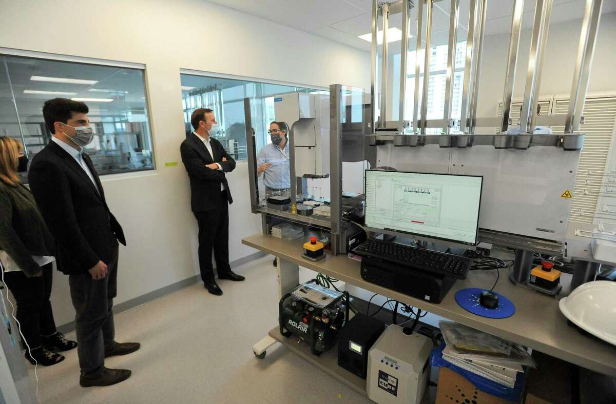State Rep. Matt Blumenthal, at left, and Sen. Chris Murphy, at center, tour Sema4's laboratory at 62 Southfield Ave., in Stamford, Conn., on Sept. 18, 2020.