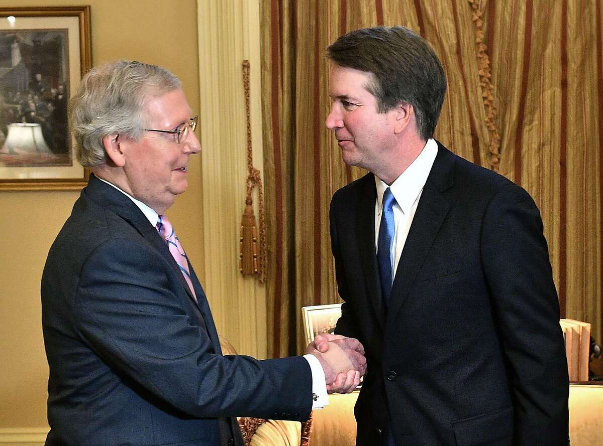 US Senate Majority Leader Mitch McConnell (L) welcomes Supreme Court associate justice nominee Brett Kavanaugh in McConnell's office at the US Capitol in Washington, DC. on July 10, 2018. (Photo by MANDEL NGAN / AFP) (Photo credit should read MANDEL NGAN/AFP via Getty Images)