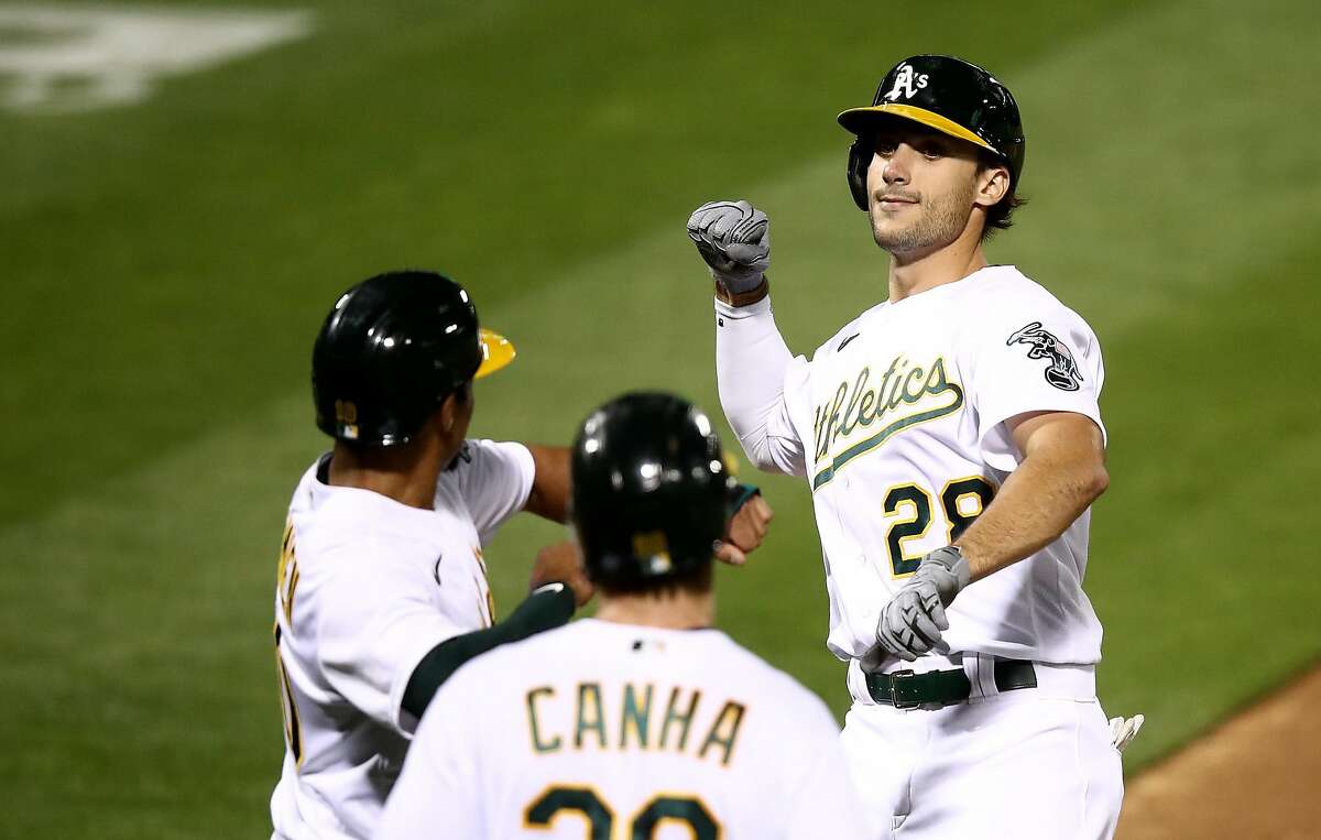 OAKLAND, CALIFORNIA - SEPTEMBER 18: Matt Olson #28 of the Oakland Athletics is congratulated by Marcus Semien #10 after he hit a three-run home run off of Logan Webb #62 of the San Francisco Giants in the third inning at RingCentral Coliseum on September 18, 2020 in Oakland, California. (Photo by Ezra Shaw/Getty Images)