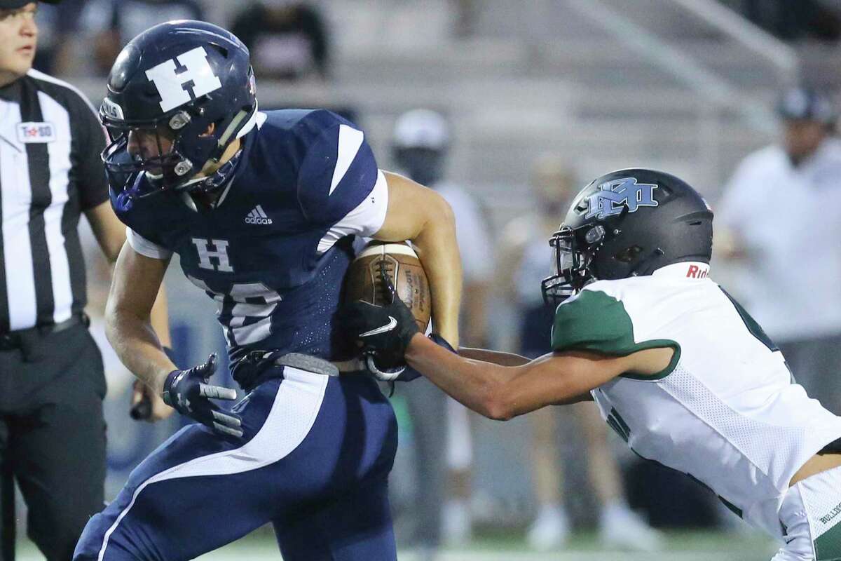 Marion's Dominic Castellanos (04) attempts to strip the ball from Hondo's Trek Dickens (22) during their high school football game in Hondo, Texas on Friday, Sept. 18, 2020.