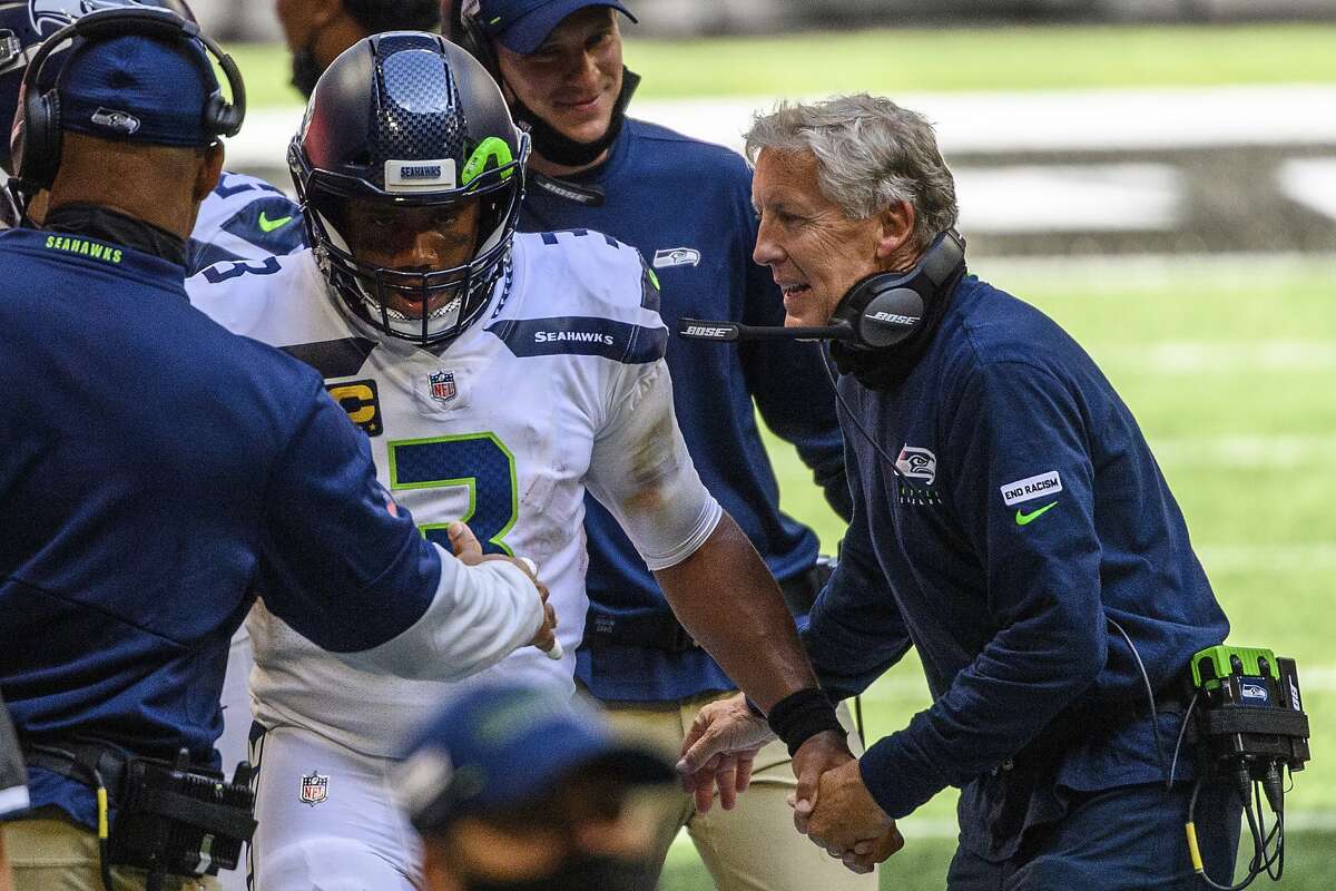 Seattle Seahawks head coach Pete Carroll shakes hands with quarterback Russell Wilson (3) on the sideline during the second half of an NFL football game against the Atlanta Falcons, Sunday, Sept. 13, 2020, in Atlanta. The Seattle Seahawks won 38-25. (AP Photo/Danny Karnik)