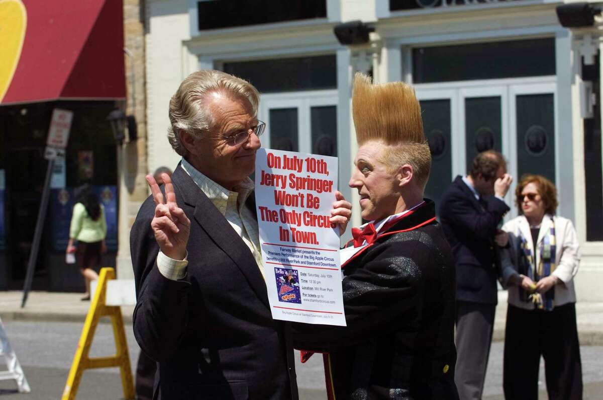 Talk show host Jerry Springer speaks to the crowd with Bello Nock, the world famous daredevil clown, and star of the Big Apple Circus in Columbus Park on Tuesday May 4, 2010 in Stamford, Conn.