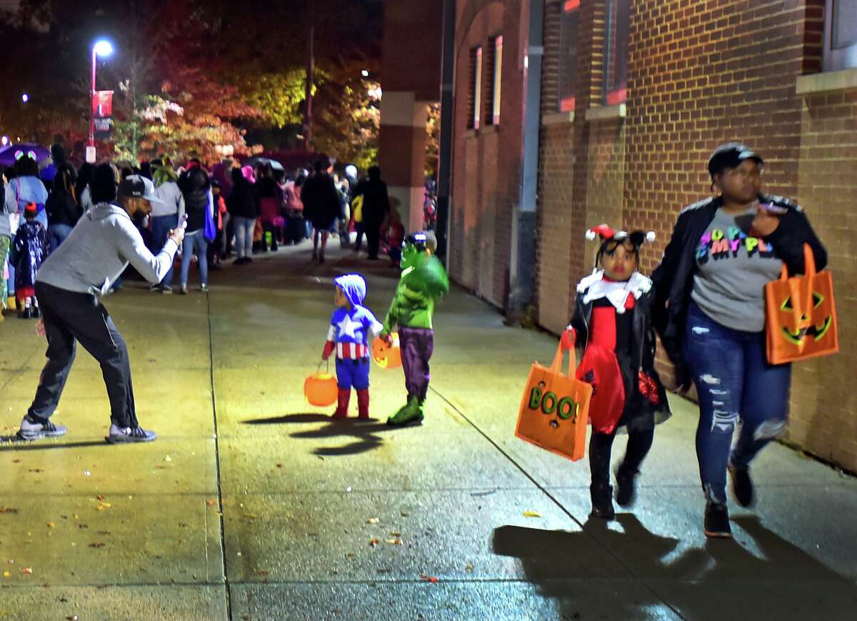 New Haven, Connecticut -Wednesday, October 31, 2019: New Haven's "Trunk-of-Treat" festive halloween event at Wilbur Cross H.S. Thursday evening, sponsored by CIty of New Haven Departments of Parks, Recreation, and Trees & Youth Services was packed costumed children and adults celebrating with City of New Haven representatives, neighborhood community and civic organizations, clubs, New Haven area university organizations, and many other groups who gave out candy.