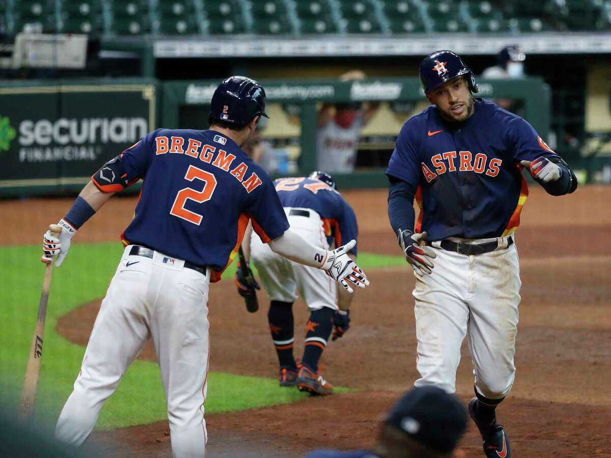 Houston Astros George Springer celebrates with Alex Bregman after his second home run of the day during the seventh inning of an MLB baseball game at Minute Maid Park, Sunday, September 20, 2020, in Houston. Springer's home run was the 2000th home run in Minute Maid Park.