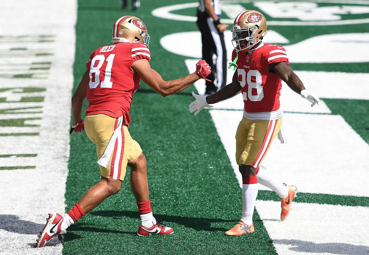 EAST RUTHERFORD, NEW JERSEY - SEPTEMBER 20: Jordan Reed #81 of the San Francisco 49ers reacts with Jerick McKinnon #28 after scoring a touchdown during the first half of the game against the New York Jets at MetLife Stadium on September 20, 2020 in East Rutherford, New Jersey. (Photo by Sarah Stier/Getty Images)