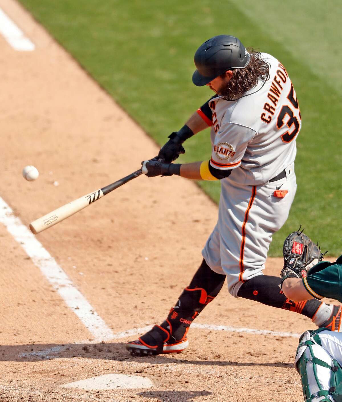 San Francisco Giants' Brandon Crawford connects on a 6th inning grand slam against Oakland Athletics in MLB game at Oakland Coliseum in Oakland, Calif., on Sunday, September 20, 2020.