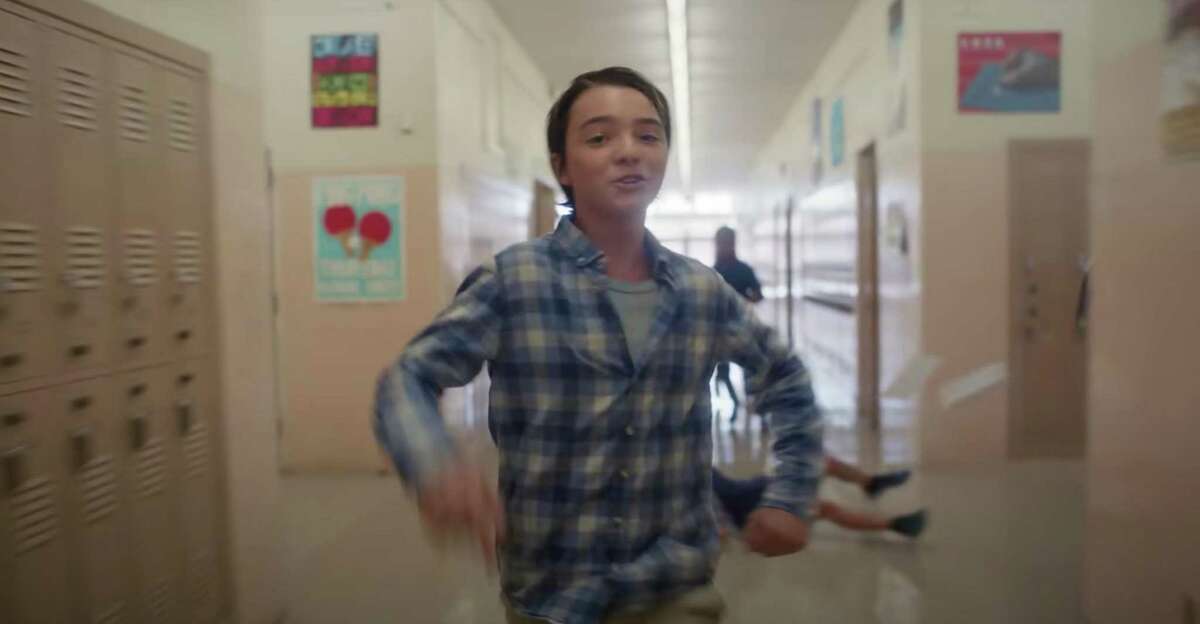 A student, grateful for his sneakers, sprints down a hallway to flee gunfire in Sandy Hook Promise’s ‘Back-to-School Essentials’ public service announcement.