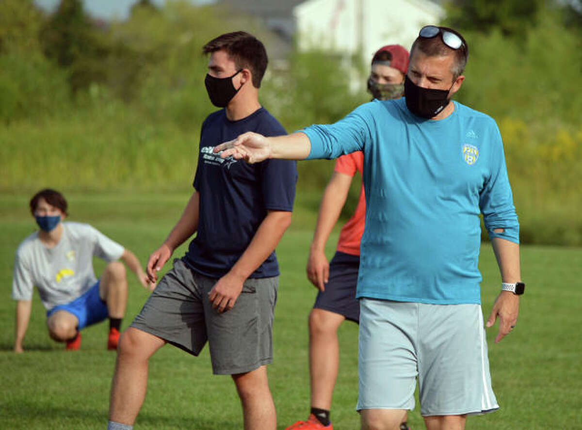 Father McGivney boys soccer coach Matt McVicar gives instructions to his players during practice last week.