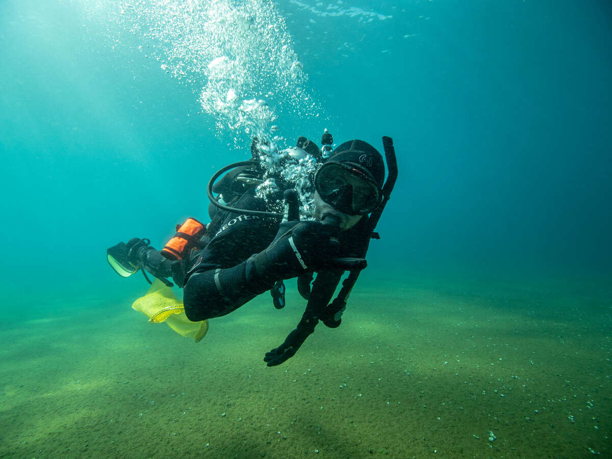 Scuba divers pick up trash in Lake Tahoe near Nevada Beach on Thursday, August 27, 2020.