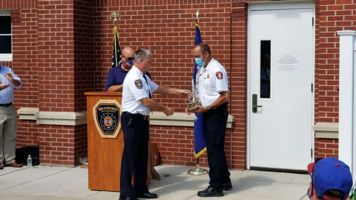 Branford Fire Chief Tom Mahoney, center, makes a presentation to retiring Branford Fire Department Deputy Chief and Fire Marshal Shaun Heffernan, right, at his retirement ceremony on Sept. 11, 2020.