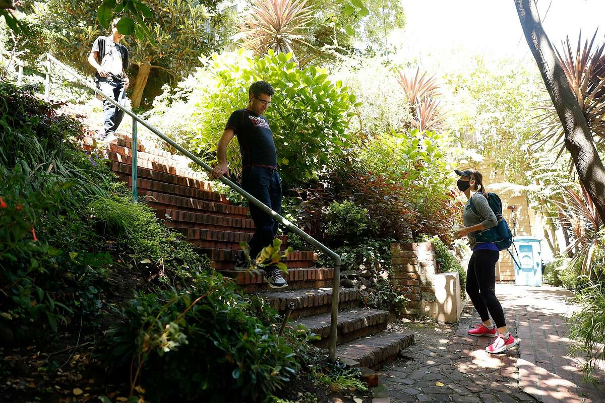 Alexandra Kenin waits for two people to pass while climbing the Greenwich Street steps in Telegraph Hill neighborhood of San Francisco, Calif., on Wednesday, August 12, 2020. Kenin has climbed all 900 outdoor staircases in San Francisco and logged them online.