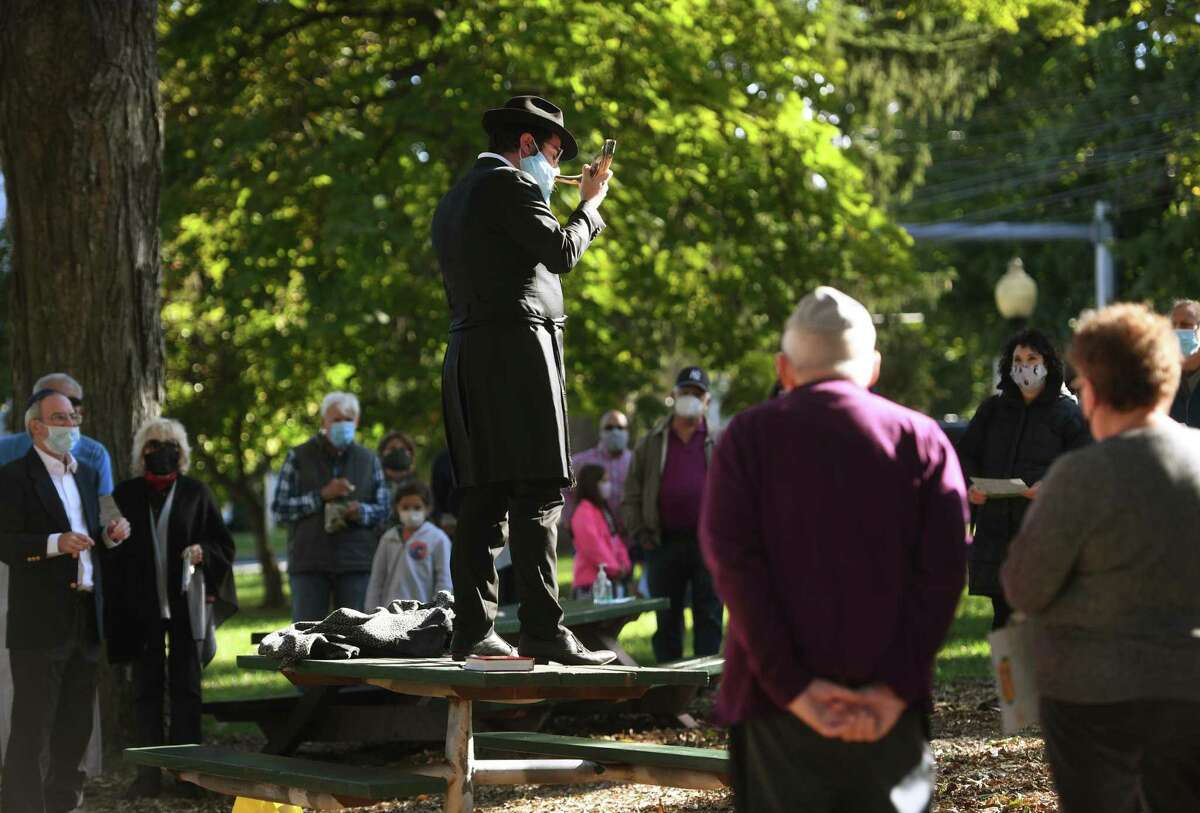 Rabbi Schneur Brook from Chabad of Shelton-Monroe blows the shofar during an outdoor Rosh Hashanah service on the Huntington Green in Shelton on Sunday.