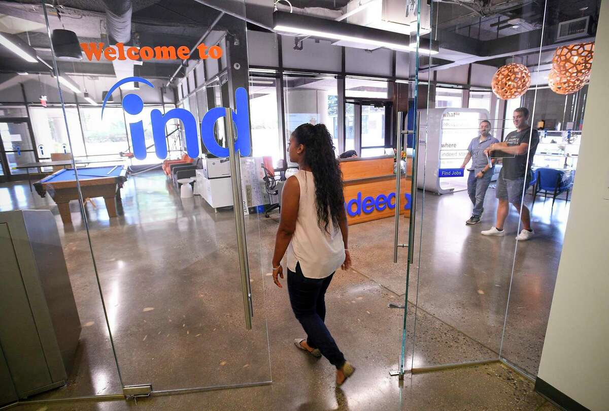 An employee of Indeed enters its offices at 177 Broad St., in downtown Stamford, Conn in 2019. Indeed has been named one of the top large employers in the 2020 Hearst Top Workplaces competition.