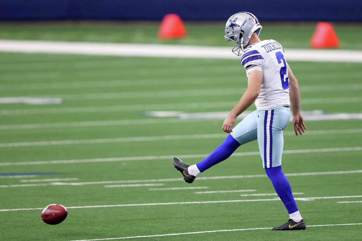 Greg Zuerlein kicks an onside kick against the Falcons in the fourth quarter Sunday at AT&T Stadium.