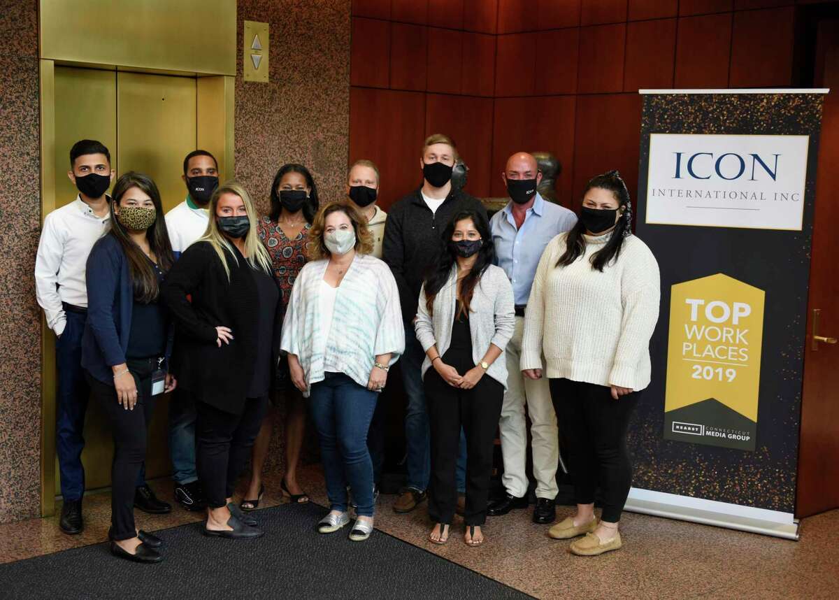 ICON International employees pose at the company’s headquarters in Greenwich, Conn. Wednesday, Sept. 16, 2020. The specialized finance company focuses on corporate barter transactions.
