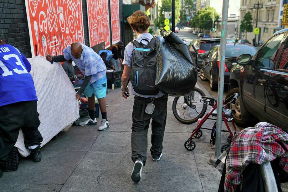 Will Andrews, a homeless man struggling with drug addiction, carries belongings in a garbage bag while making his way down Jones St. toward Eddy. Photo: Guy Wathen / The Chronicle / **MANDATORY CREDIT FOR PHOTOG AND SF CHRONICLE/NO SALES/MAGS OUT/TV