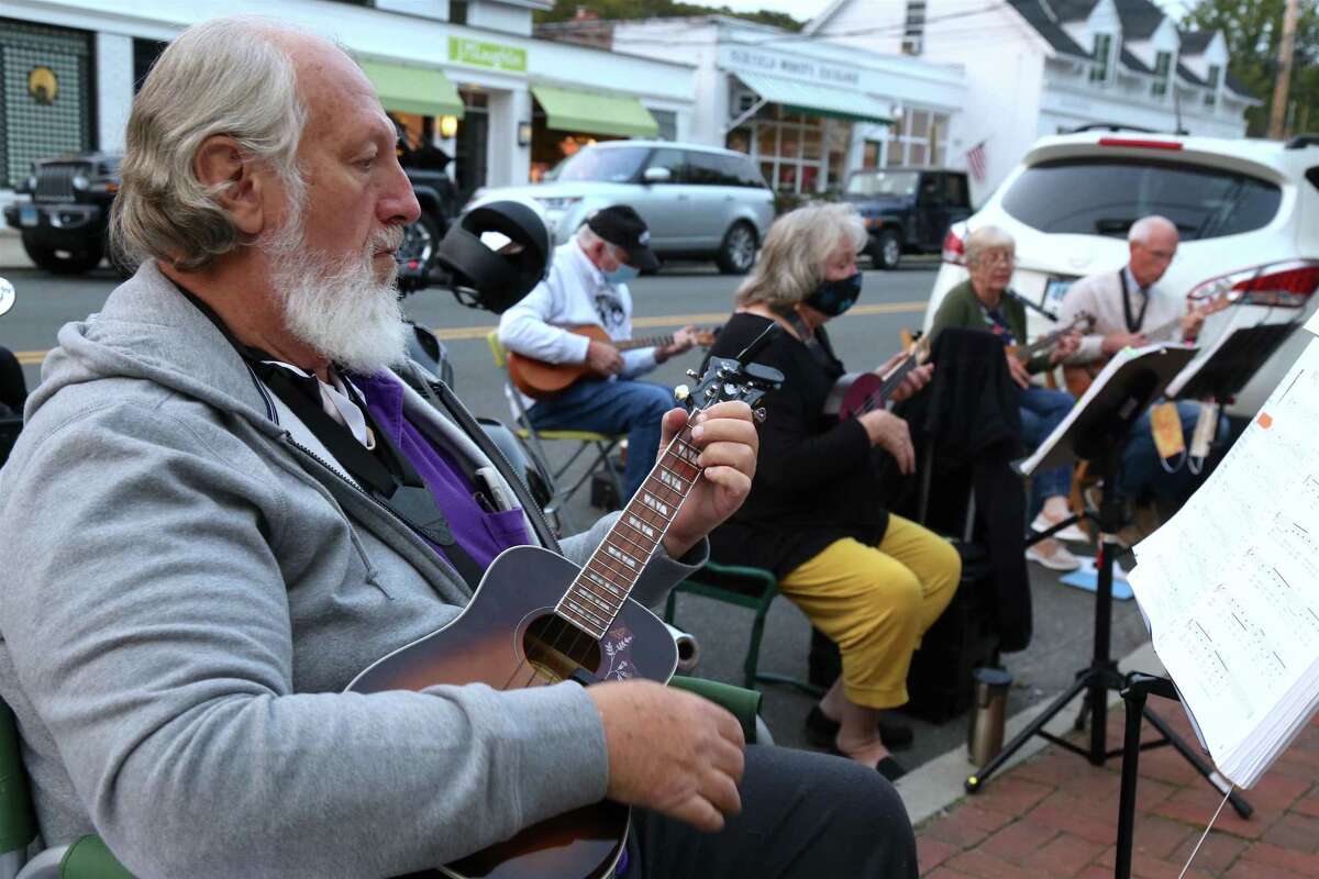 John Pyrch of Black Rock and others sing and play at the monthly ukulele meet-up outisde the Horseshoe Cafe on Tuesday, Sept.15, 2020, in Fairfield, Conn.