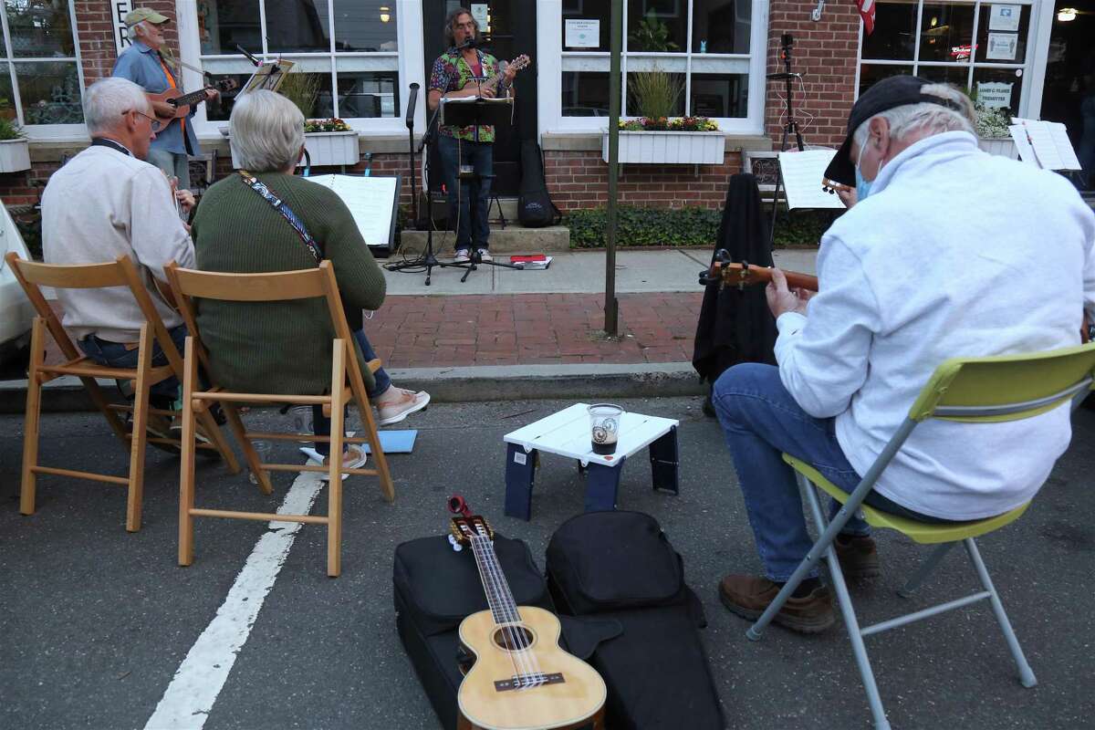 The sidewalk was full of music at the monthly ukulele meet-up outisde the Horseshoe Cafe on Tuesday, Sept.15, 2020, in Fairfield, Conn.