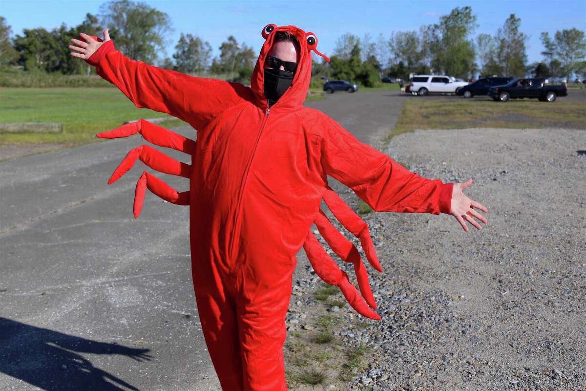 Volunteer Craig Patton of Westport gets into the seafood spirit at the ShoreFest on a Roll event at Sherwood Island State Park on Sunday, Sept. 20, 2020, in Westport, Conn. "We thought about all kinds of ways to do things safely and we realized that we wanted to continue the local person's experience of Sherwood Island," explained Cece Saunders, who co-chaired the event with Westporter Steve Axthelm. The Friends made pickup food available through their annual vendor, Westfair Fish & Chips, which provided lobster rolls, slaw and more. At the same time, when people drove into the park to get their food, they were also encouraged to enjoy various fun features taking place, including several bands that were performing, immense kites that were being flown, and the model airplane escapades of the Country Squire Modelers club, which has operated on the northeastern side of the park since the 1970s.