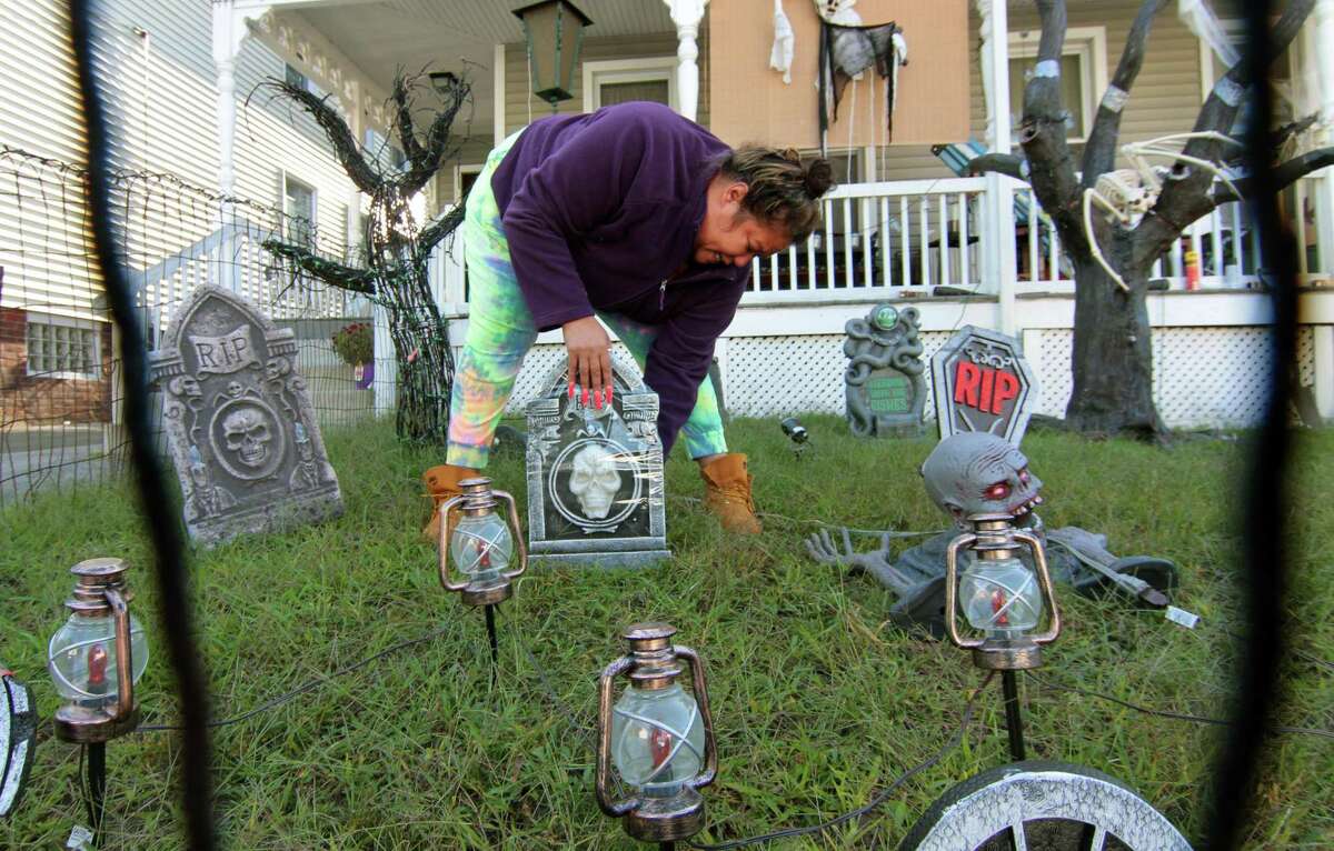 Chanel Owens sets up Halloween decorations in front of her home on Howard Avenue in Ansonia, Conn., on Tuesday Sept. 22, 2020.
