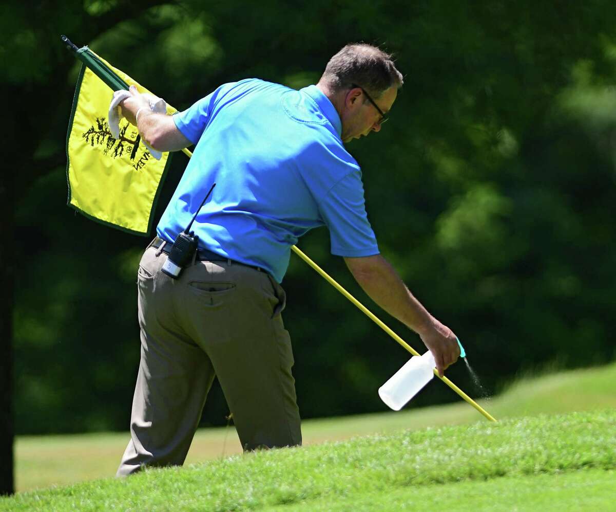 Tournament Director Doug Evans wiped down the flag on one of the greens during the Northeastern New York PGA Pro Classic 3 at Pinehaven Country Club on Monday, June 22, 2020 in Guilderland, N.Y. (Lori Van Buren/Times Union)