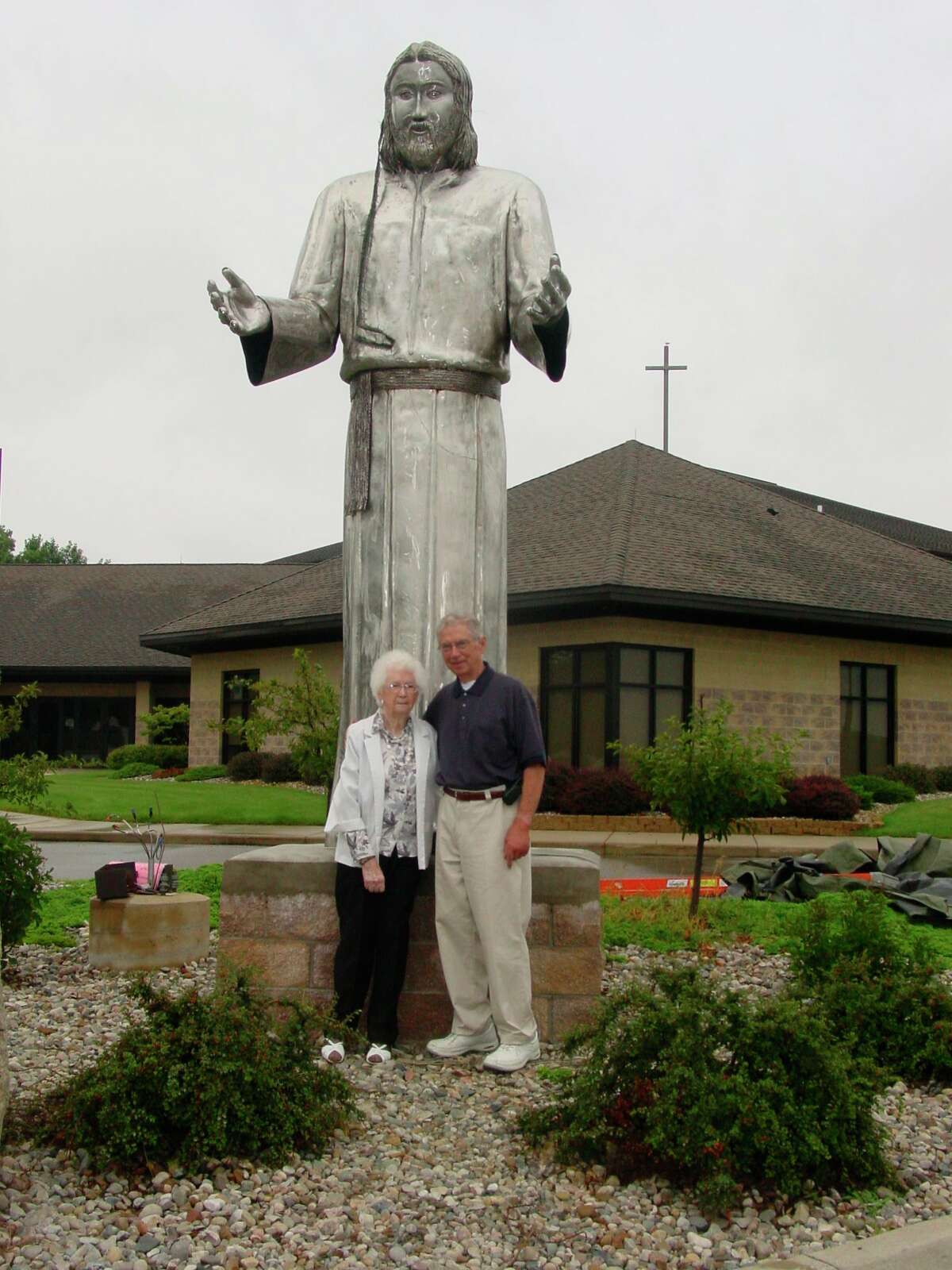 Emily Allen and her son Ernie of Midland pose with the statue of Jesus Christ in front of Messiah Lutheran Church. Ernie and his friend Jim Leigeb worked on the statue for over a year to present to the church. (Photo provided/Facebook)