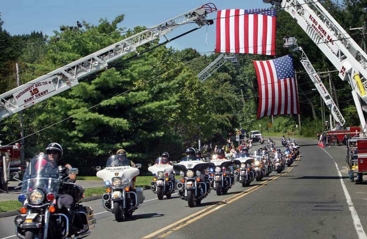 Trumbull Police lead the annual CT United Ride makes its way down Main St. in Trumbull on Sunday, August 29, 2010. The ride is held as a 9/11 tribute and, this year, honors fallen firefighters, Steven Velasquez and Michel Baik.