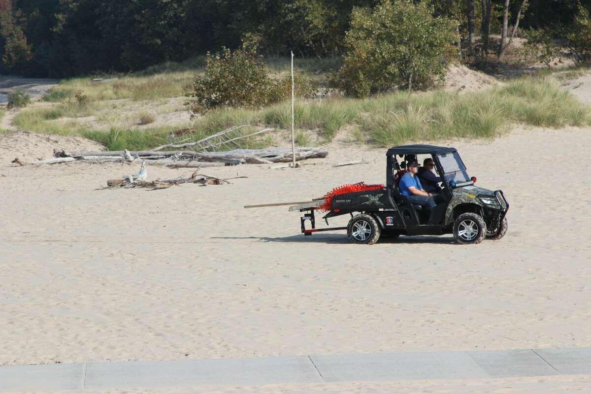 Frankfort Fire and Rescue use an ATV to move equipment after areas of the beach and pier were closed to the public during the search and recovery of a body on Sept. 23.