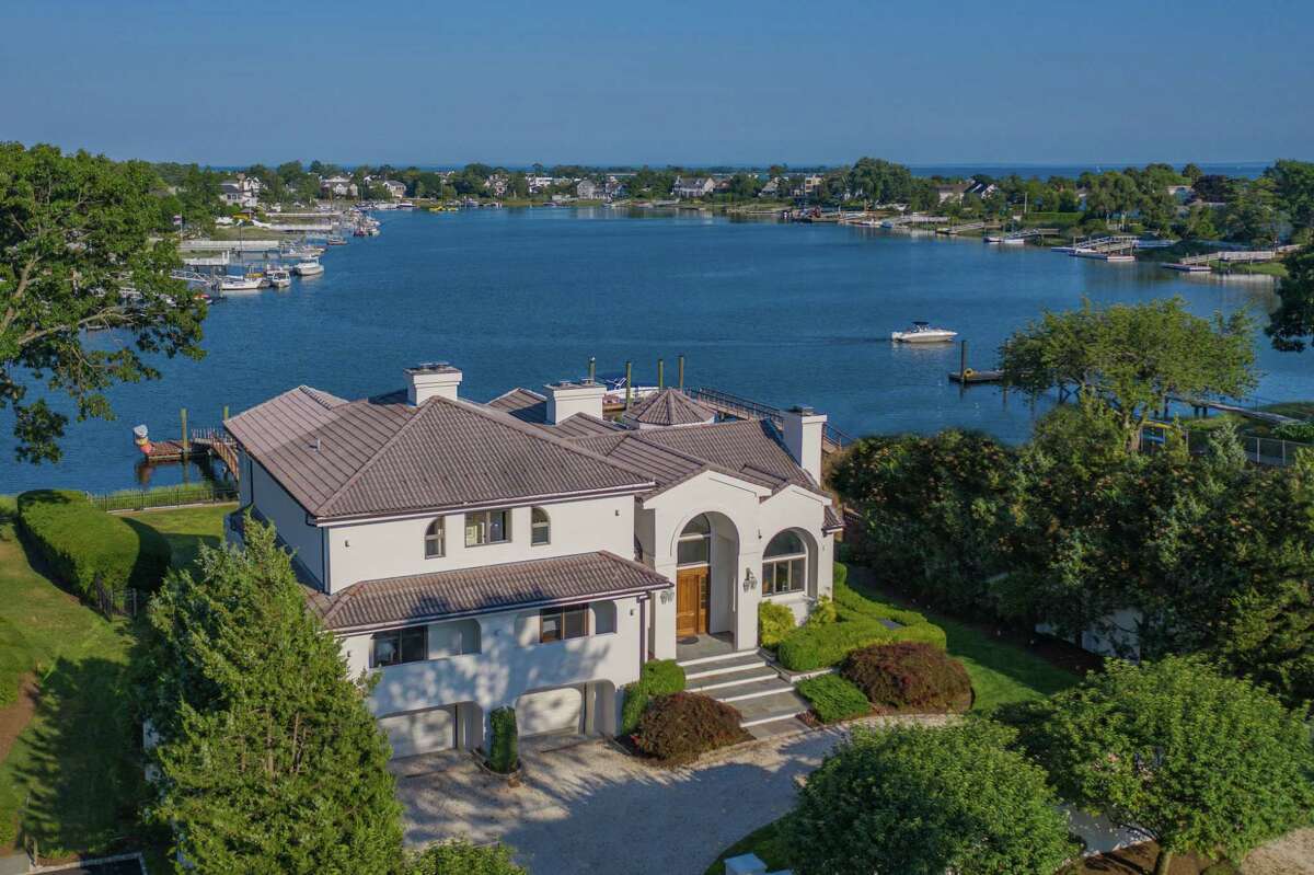 The Mediterranean-style white stucco house at 11 Covlee Drive in Westport's Saugatuck Shores sits along Bermuda Lagoon. Although this house was constructed decades ago in 1989, the architect and builder clearly took advantage of the beautiful waterfront setting, and they projected into the future giving this house spacious rooms in an open concept floor plan within 4,674 square feet of living space. The footprint of the house is much bigger than could be built in this area today, according to the listing agent.