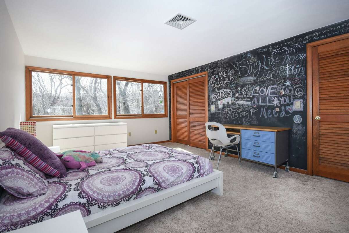 One of this home's six bedrooms has a chalk paint wall. Of course, this property is large enough for its next owners to create gardens of their own; perennial flower beds, vegetable gardens and a culinary herb garden.