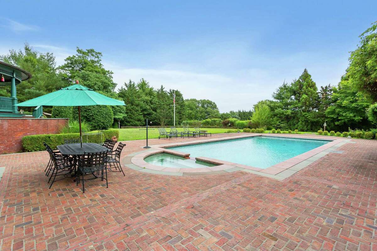 This property features a 20'x40' heated Gunite in-ground swimming pool and spa but is also walking distance to Sasco Beach. And yet, the construction project infused those classic Queen Anne Victorian-style elements with modern-day amenities inside and out including a gourmet kitchen, a vast red brick patio, heated Gunite in-ground swimming pool and spa, fire pit, built-in barbecue with a cooktop, home theater with plush seating, an elevator, and a private apartment with a full kitchen, bedroom, living room, and its own laundry.