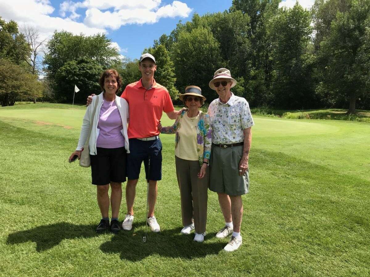 Ted Broadwell (far right) and his family (from left) daughter Julie Holmes, grandson Eric Holmes, and wife Barb pose for a picture near the 18th green after Broadwell recently shot his age or better for the 1,000th time at Currie Municipal Golf Course.