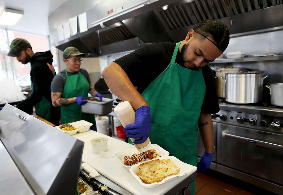 At Vegan Mob in Oakland, Daniel Esparza drizzles sauce on a vegan po’boy last year at the restaurant that offers vegan barbecue.