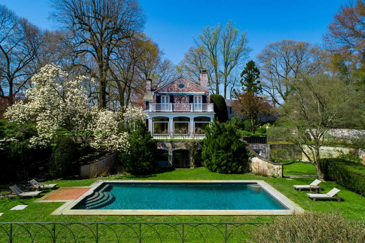 Musician Paul Simon's New Canaan, Conn. estate is on the market for $11.9 million. The grounds provide a parklike idyll with sweeping meadows, formal walled gardens and a swimming pool scenically sited on a grassy plateau with serene views over a placid private pond. Just inside the main gates and a good distance from the main house, a 2,400-square-foot cottage, which the couple used as a recording studio, makes a perfect caretaker’s home or guesthouse.