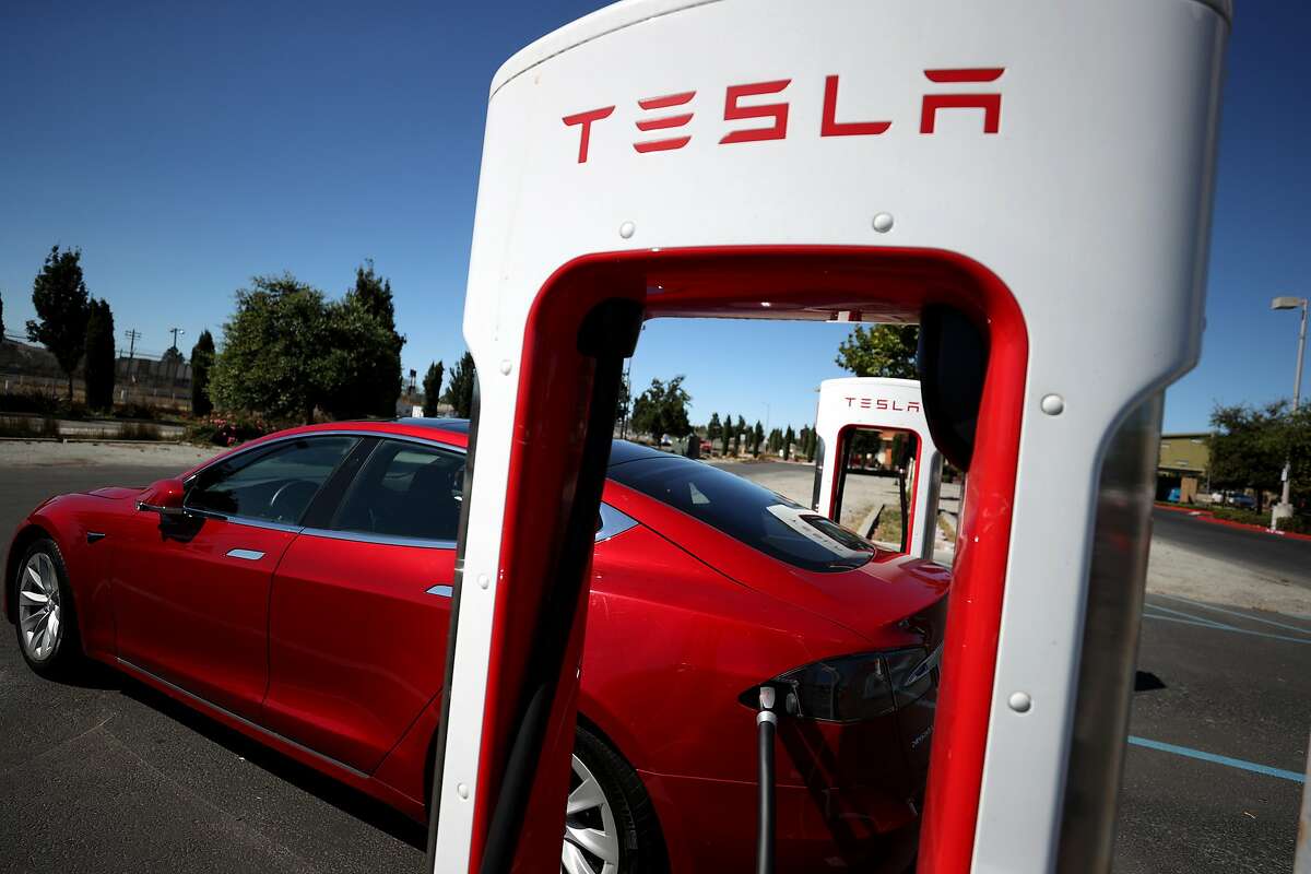 A Tesla car sits parked at a Tesla Supercharger on Sept. 23 in Petaluma. The company has released data about diversity in its workforce that shows it has room for improvement in hiring and promoting Black people.
