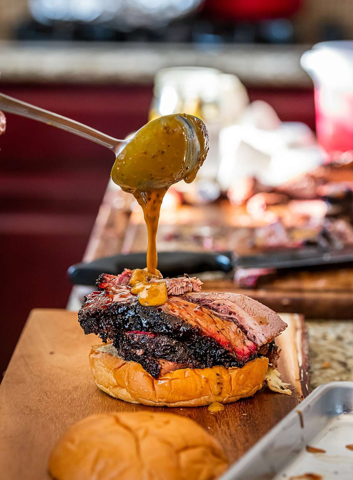 Sandwiches, including tri-tip, pulled pork and the pictured brisket with pickled onions, will cost $15.