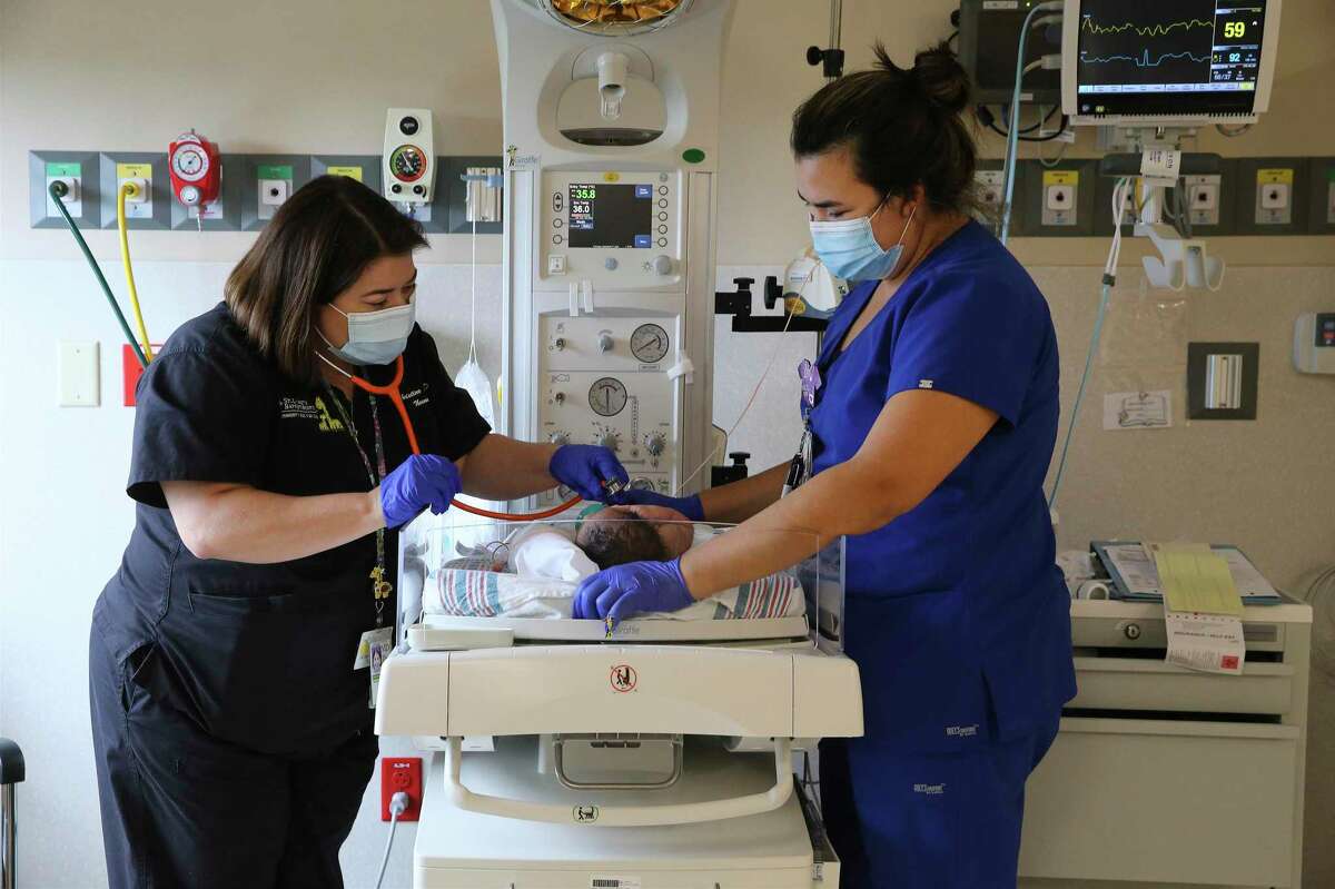 Dr. Christine Aune (left) visits with a young patientalongside Briana Villarreal, RN. San Antonio now has five of Texas’ 21 top neonatal ICUs.