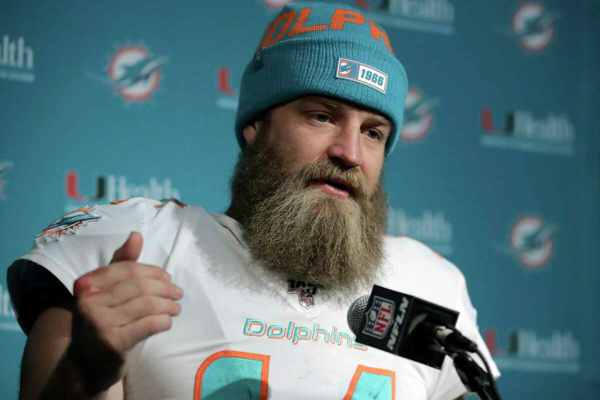FILE - In this Dec. 29, 2019, file photo, Miami Dolphins quarterback Ryan Fitzpatrick speaks to the media following an NFL football game against the New England Patriots in Foxborough, Mass. Quarterback facial hair is sure to be front and center when the Jacksonville Jaguars (1-1) host the Miami Dolphins (0-2) on Thursday night, Sept. 24, 2020. Miamias Ryan Fitzpatrick has a bushy beard that covers much of his face and engulfs his chin strap; Jacksonvilleas Gardner Minshew has a unkept horseshoe mustache that seems to go perfectly with his flowing locks. (AP Photo/Charles Krupa, File)