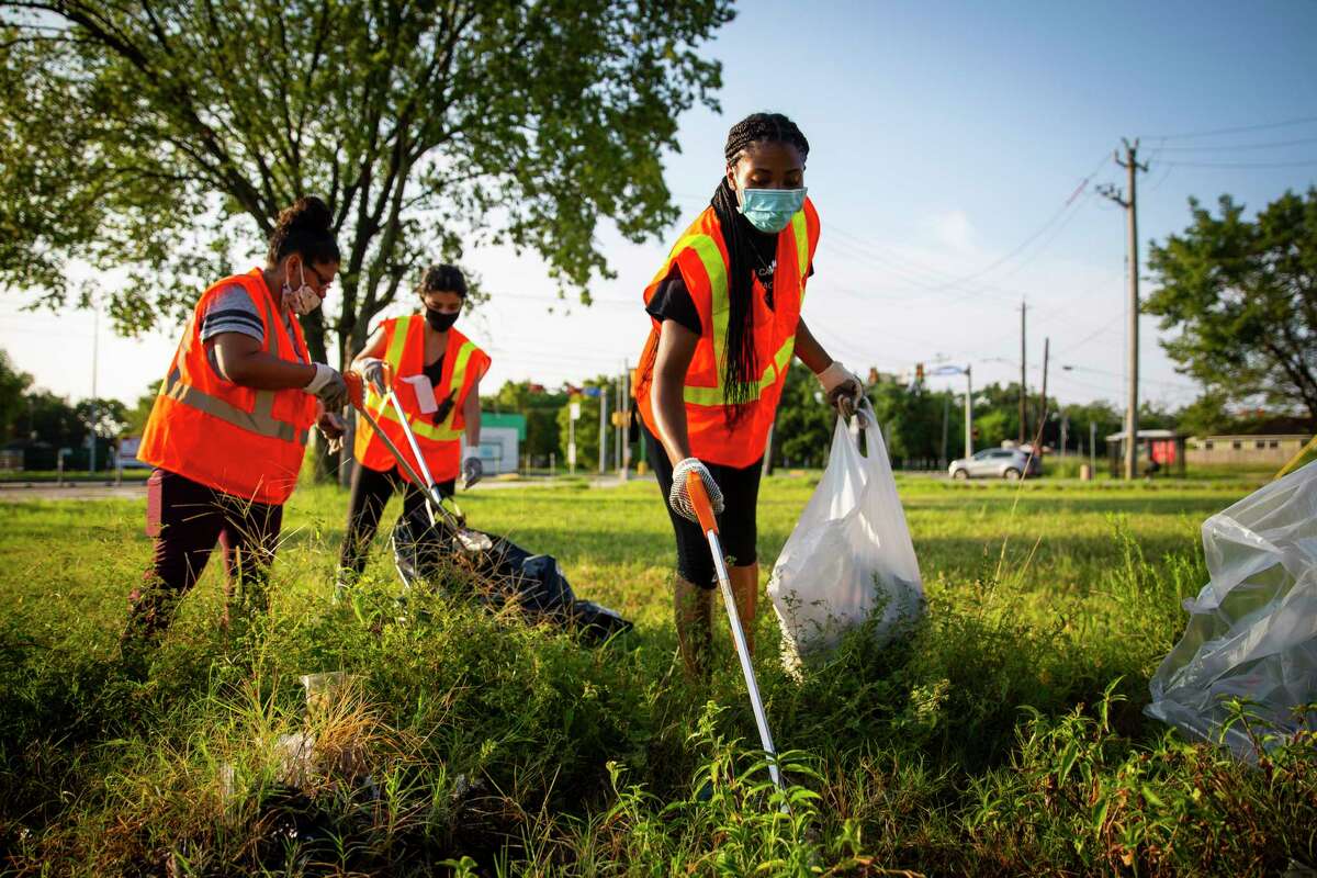 Volunteers pick up trash during a community clean up in Houston’s Third Ward.