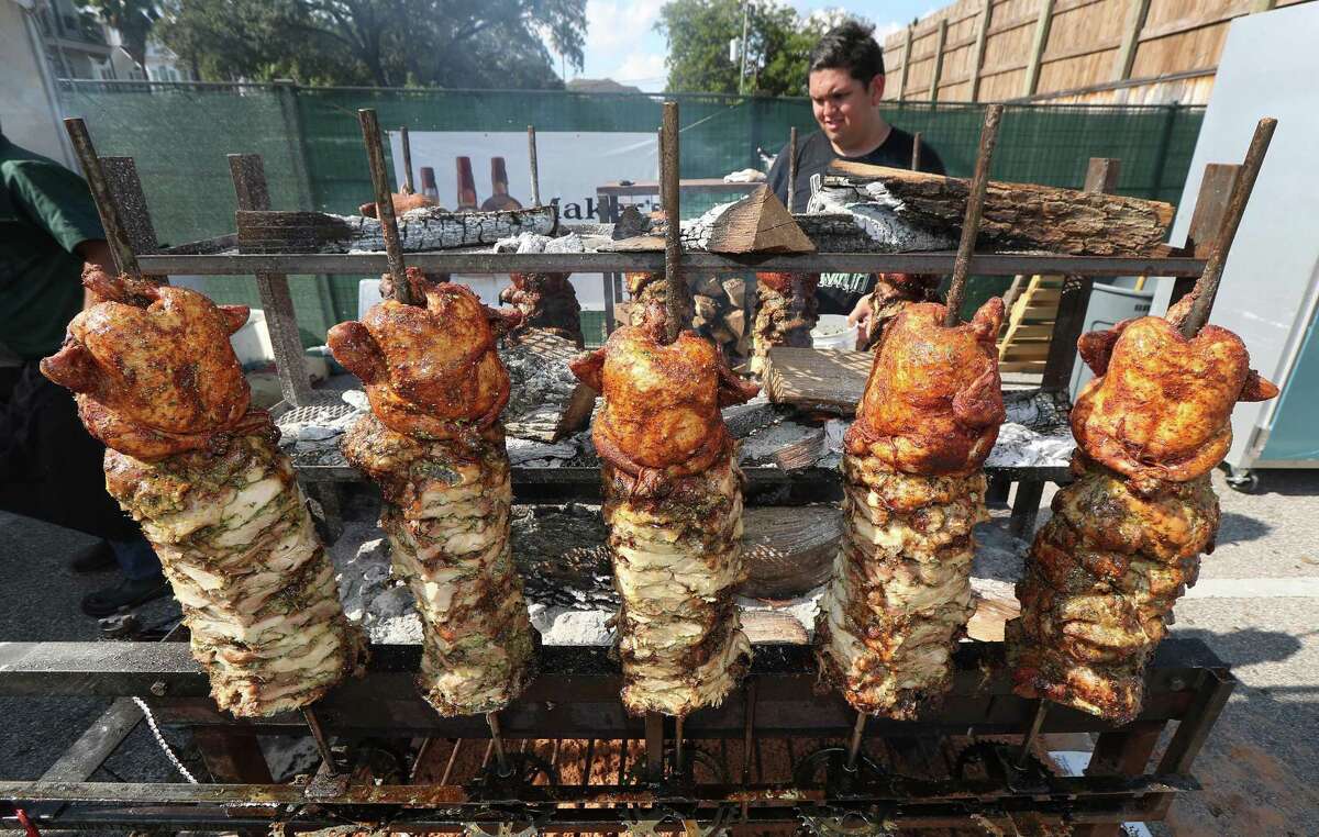 Vincent Huynh bastes chef Marcelo Garcia's chicken during last year’s Southern Smoke festival.