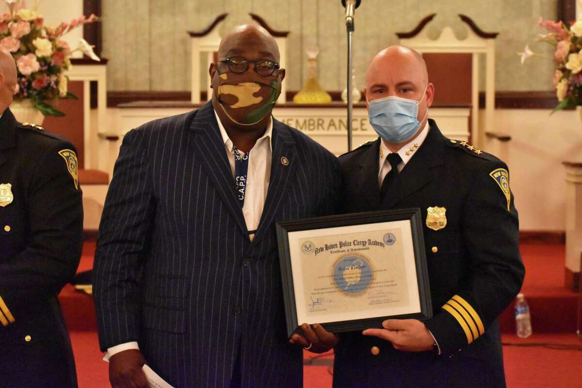 New Haven officials celebrated the graduation of 19 faith leaders from the Police Department's inaugural clergy academy Wednesday. Here, the Rev. Boise Kimber and Police Chief Otoniel Reyes pose with a certificate marking Kimber’s graduation from the academy.