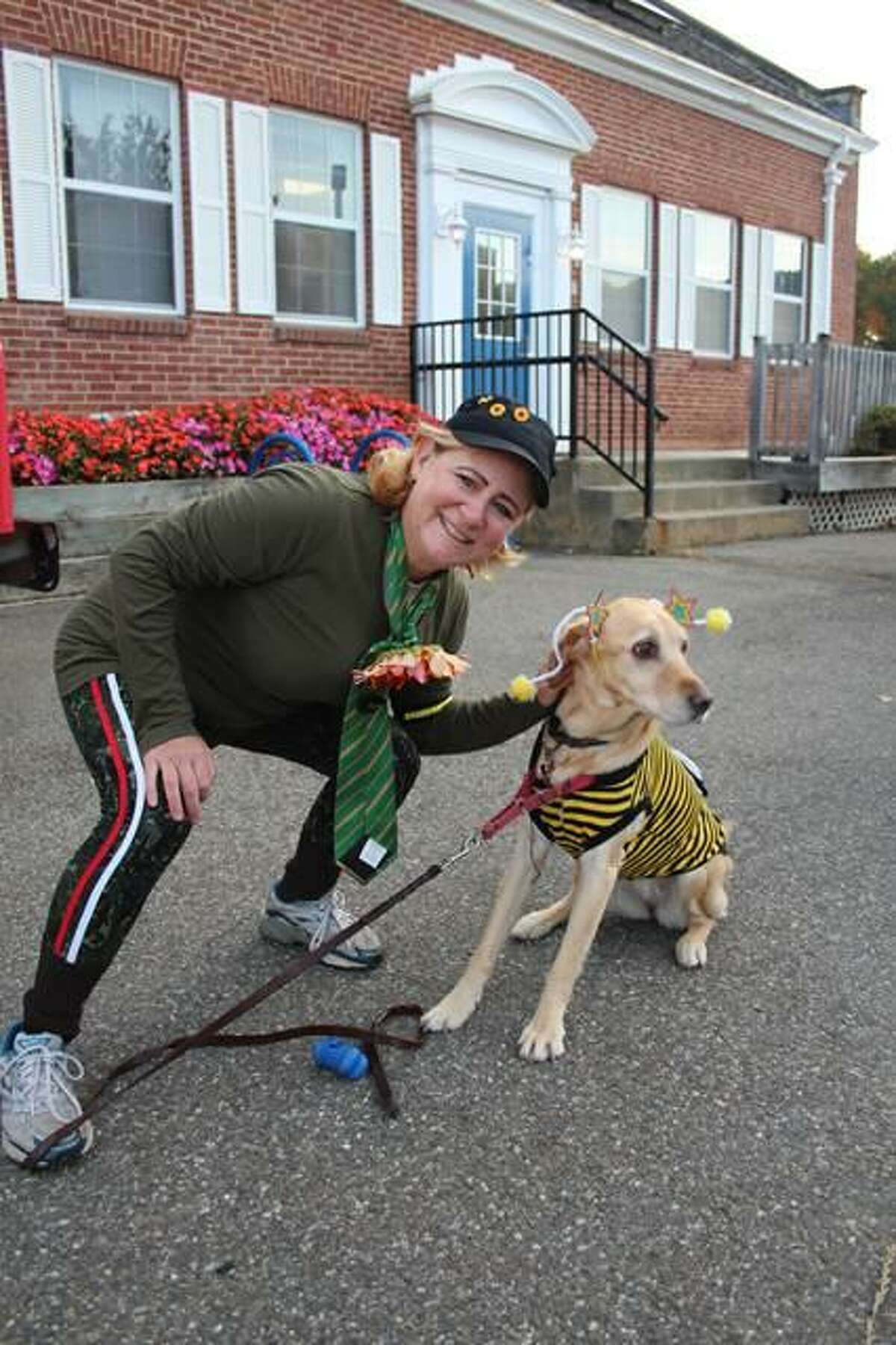 Shaileen Landsberg and her dog Abby the Labby dressed up in costume while they ran in the 2019 Milford Trick or Trot 5K fundraiser for the Beth-El Center.