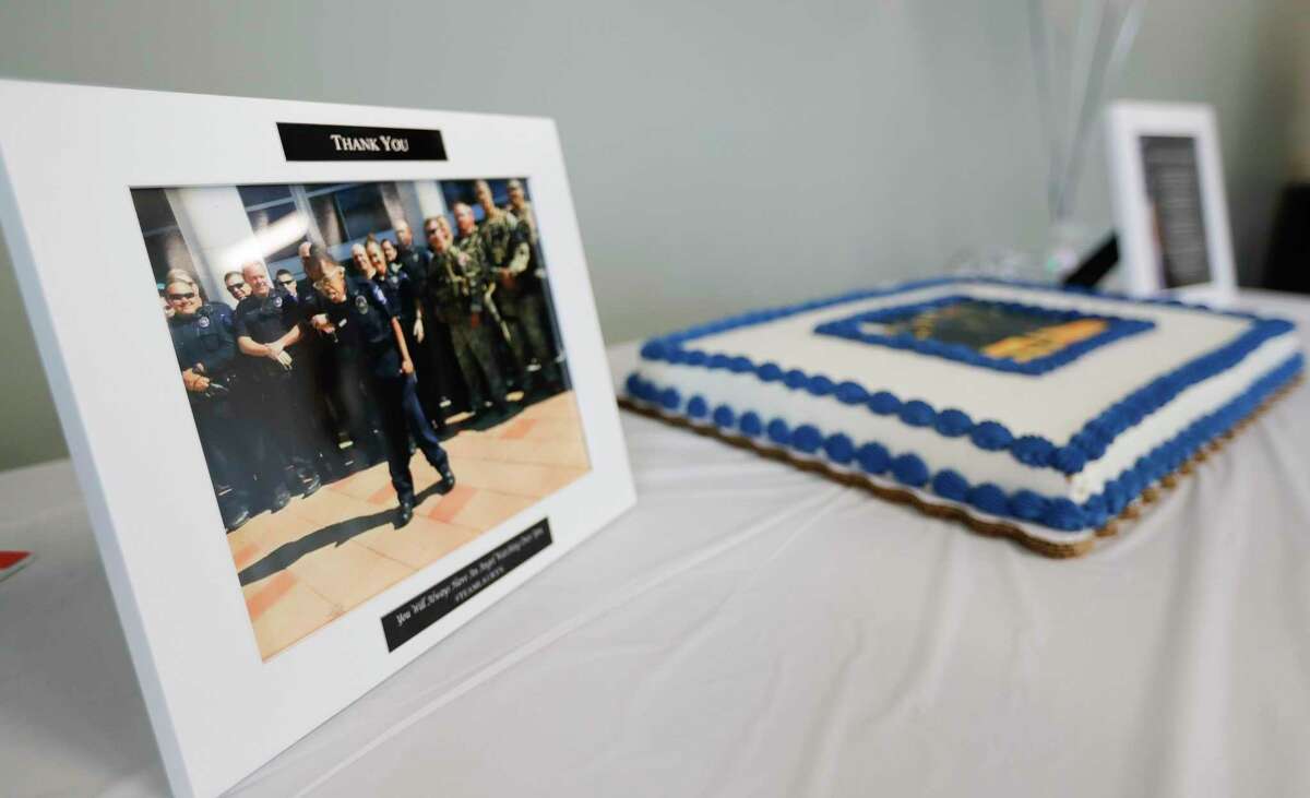An image of LaCoshia Williams’ 16-year-old daughter, Lauryn, is seen beside a cake for the Conroe Police Department, Thursday, Sept. 24, 2020, in Conroe. Lauryn died three years ago of complications from multiple medical problems due to a rare chromosomal defect, but not before being granted her wish of becoming a Conroe police officer for a day. Members of the department honored Lauryn at her funeral with an honor guard escort.