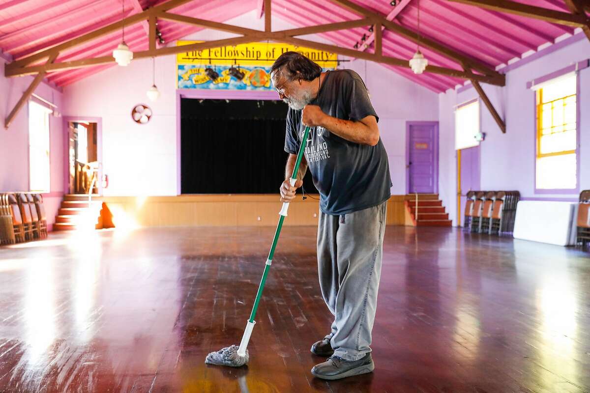 Humanist Hall event manager David Oertel mops the floors at the Oakland event space in September.