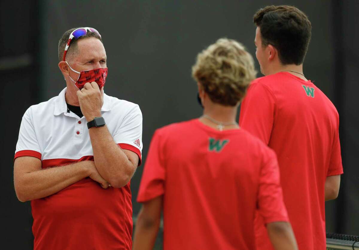 The Woodlands head coach Brett Kendall talks with players before a high school tennis match at Grand Oaks High School, Thursday, Sept. 24, 2020, in Spring.