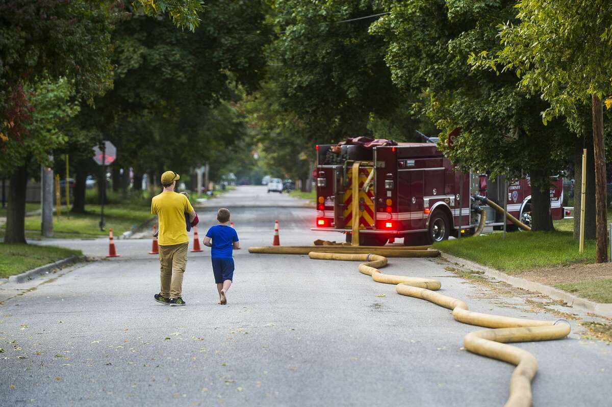 Firefighters with the City of Midland Fire Department respond to a house fire on Mill Street near Grove Thursday, Sept. 24, 2020. (Katy Kildee/kkildee@mdn.net)