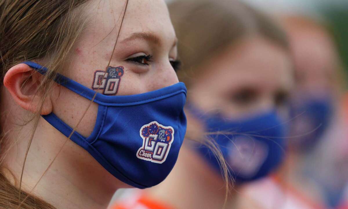 Grand Oaks cheerleader Katherine Tugwell wears a face mask as she cheers on seniors before a non-district high school football game at Woodforest Bank Stadium, Thursday, Sept. 24, 2020, in Shenandoah.